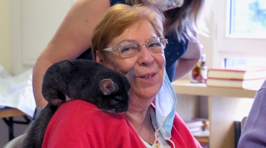 senior contente de l'atelier médiation animale en résidence